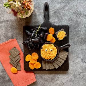 black cutting board in square shape with handle, black and orange cheese board
