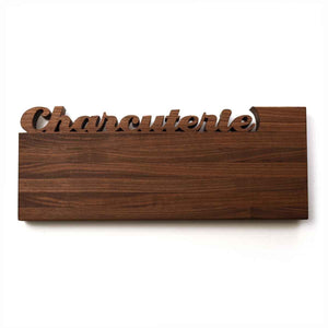 long cutting board with custom words cut out on top