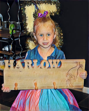 kids coat rack, girl holding her coat rack with her name carved out of the wood