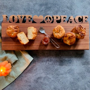 walnut wood serving board with words carved out