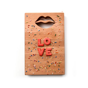 xsmall wood cutting board with the shape of lips cut out