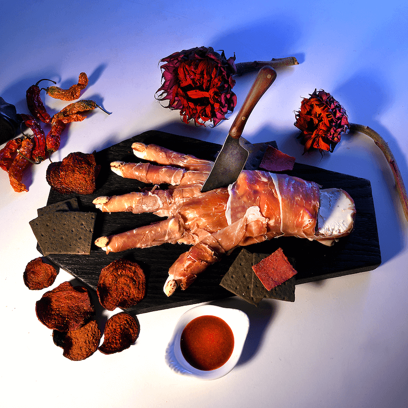 cheese shaped to look like a hand and wrapped in proscuitto