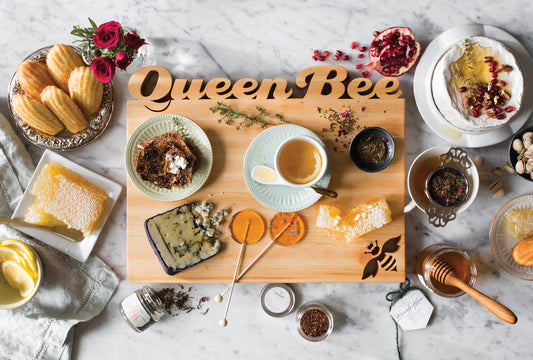 maple cutting board with "Queen Bee" cut out of top