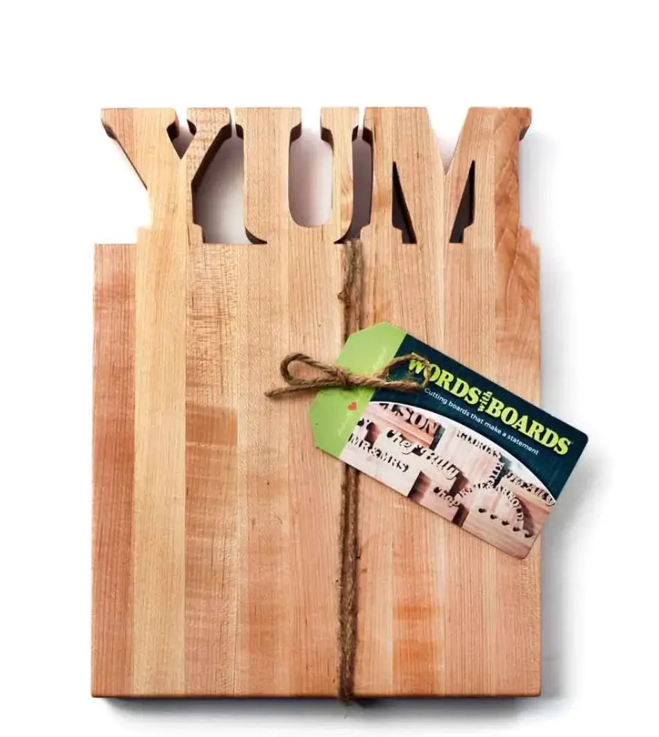 fun maple wood cutting board with the word YUM cut out of the top