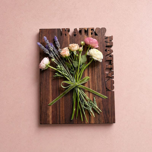rectangle walnut cutting board with 2 first names and hearts cut out of the top and side