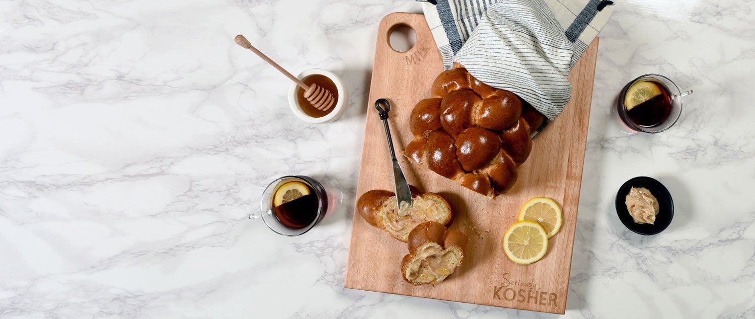 rectangle maple board with challah on marble counter