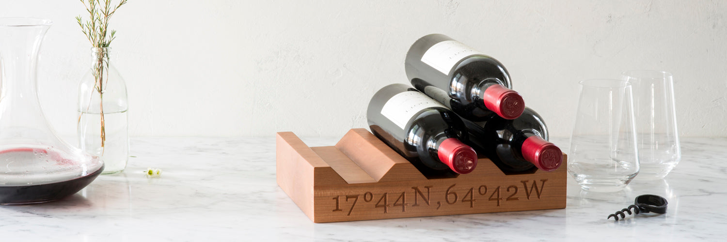 6 bottle wine rack personalized with GPS coordinates and 3 bottles of wine, on marble counter