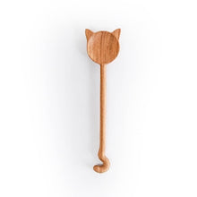 Wooden spoon with cat-shaped handle on a white background