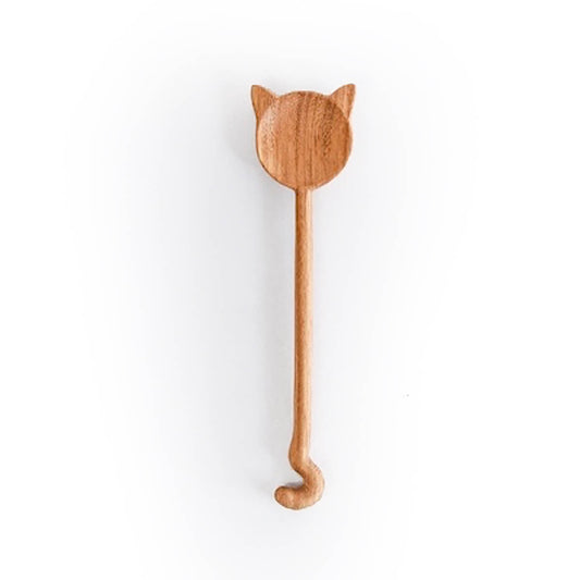 Wooden spoon with cat-shaped handle on a white background