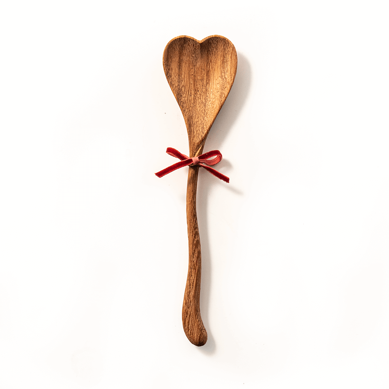 7inch wood spoon with small red bow on white background