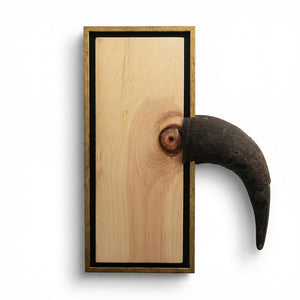 framed wood piece that looks like a bird with horn coming through frame, white background