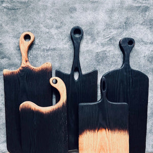 Black wooden cutting boards, charred wood