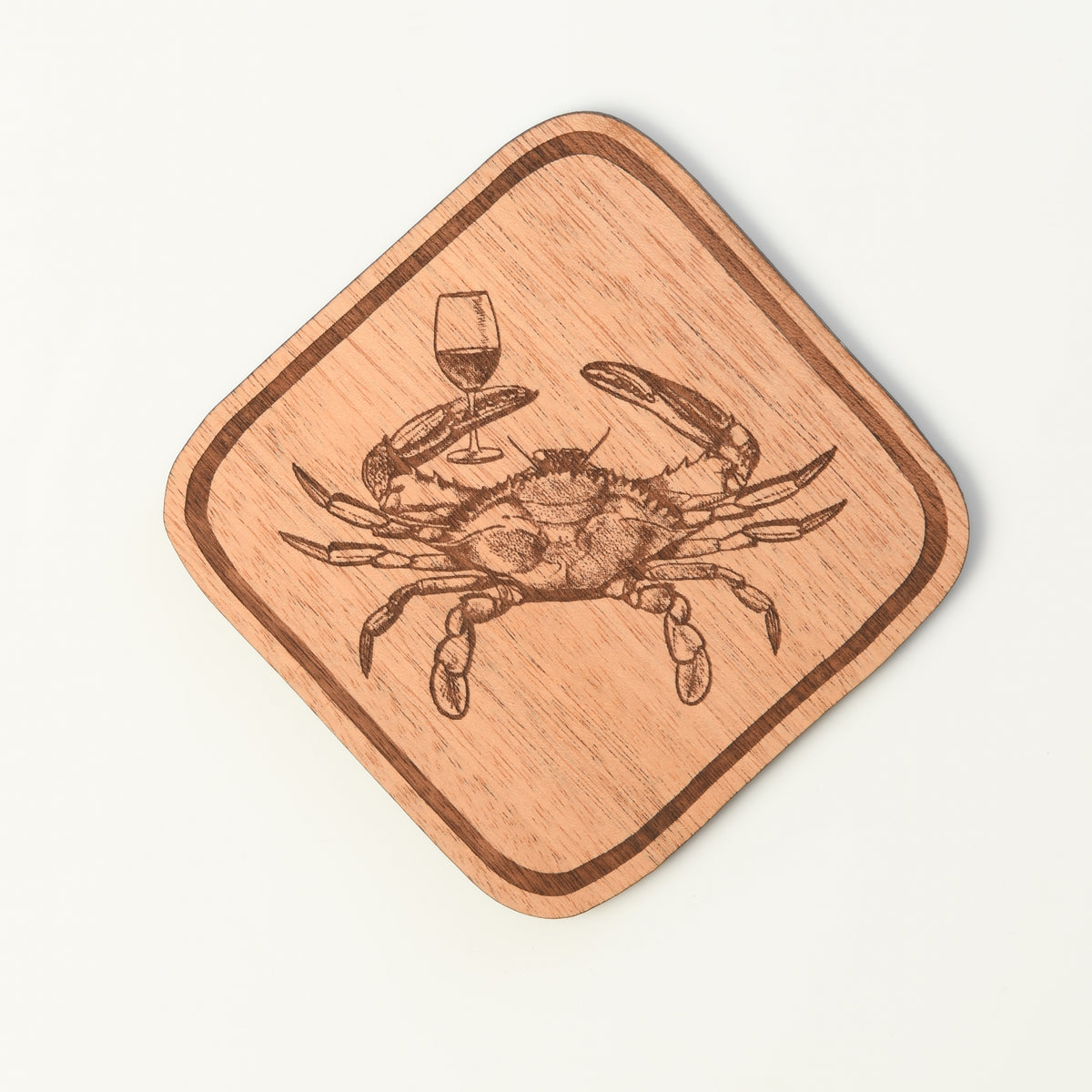 Wooden coaster with a crab and wine glass design on a white background