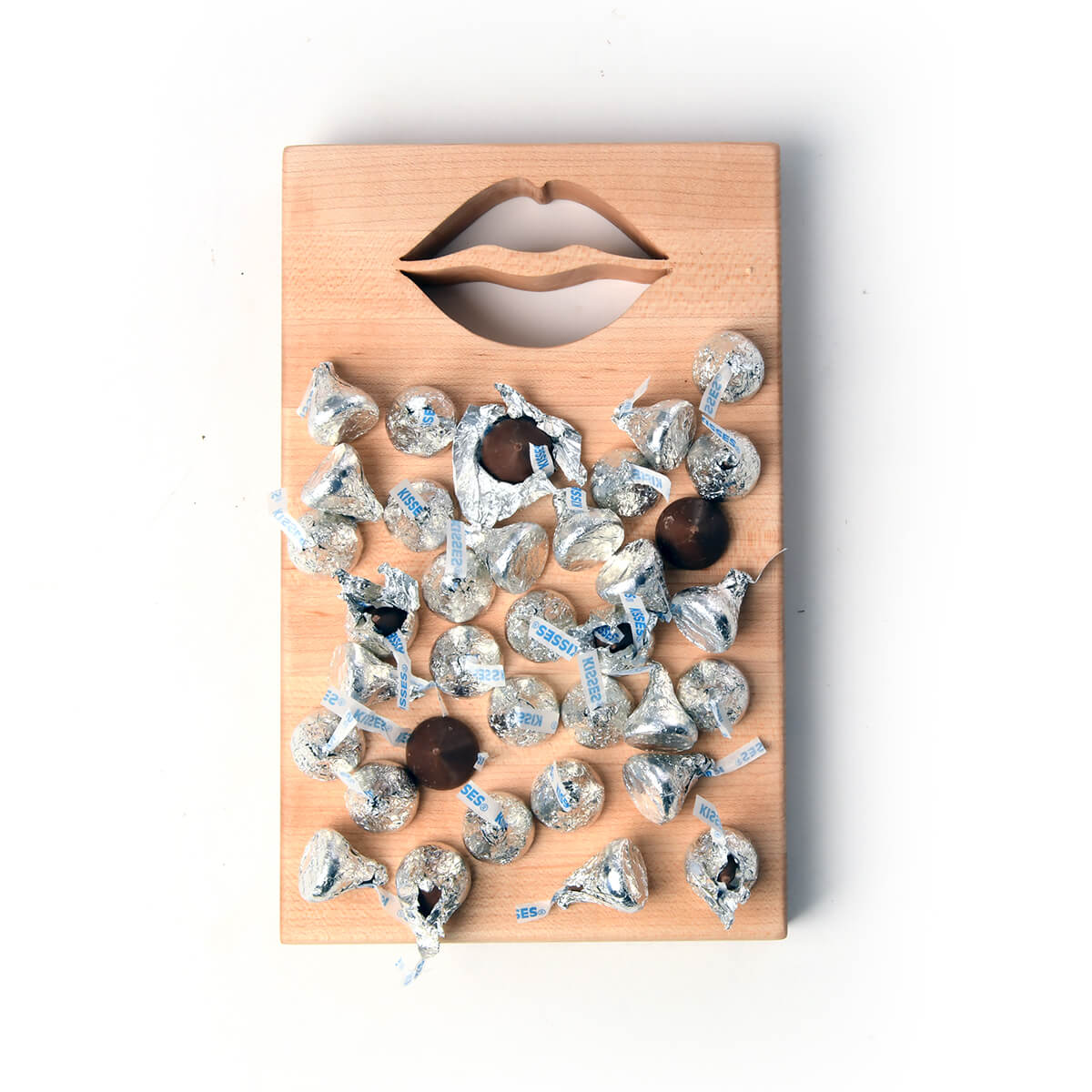 xsmall wood cutting board with the shape of lips cut out