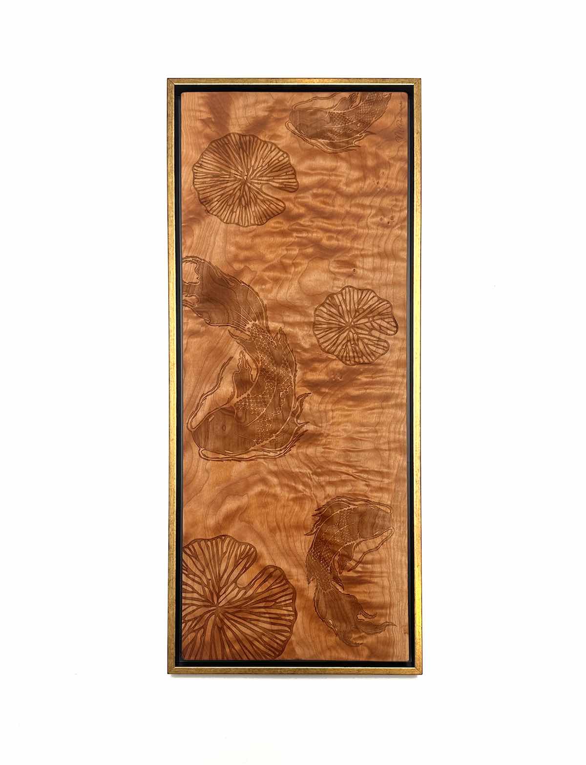 Wooden panel with engraved floral koi and lilly pond designs on a white background