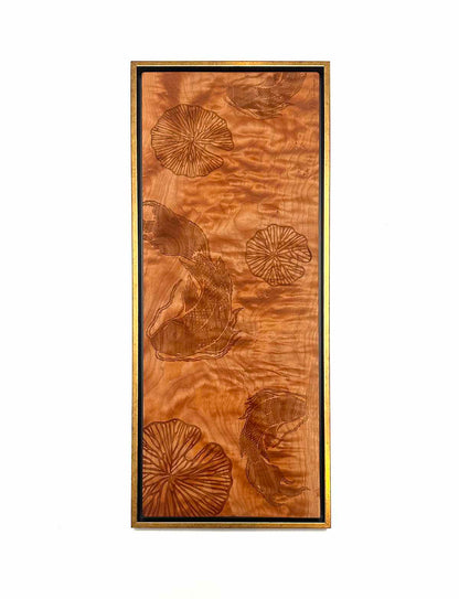 Wooden panel with engraved floral koi and lilly pond designs on a white background