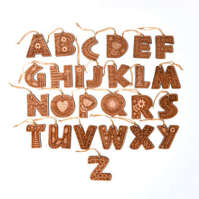 Decorative wooden alphabet letter ornaments on a white background