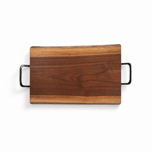 Wooden cutting board with black handles on a white background