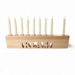 Wooden menorah with candles on a white background