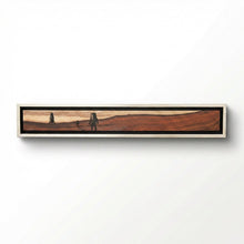 Long, narrow wood piece an astronaut and mav laser engraved with a silver frame on a white background
