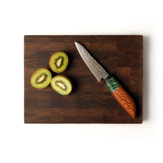 end grain board with petty knife on white background
