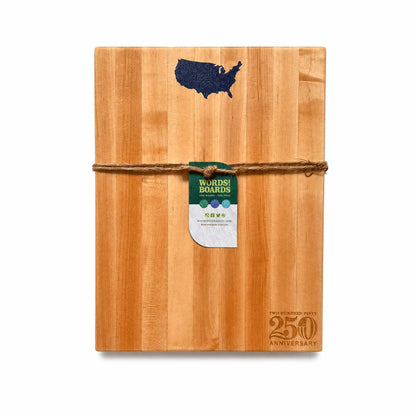Wooden cutting board with USA shape inlaid with lapis and 'Words with Boards' tag on a white background