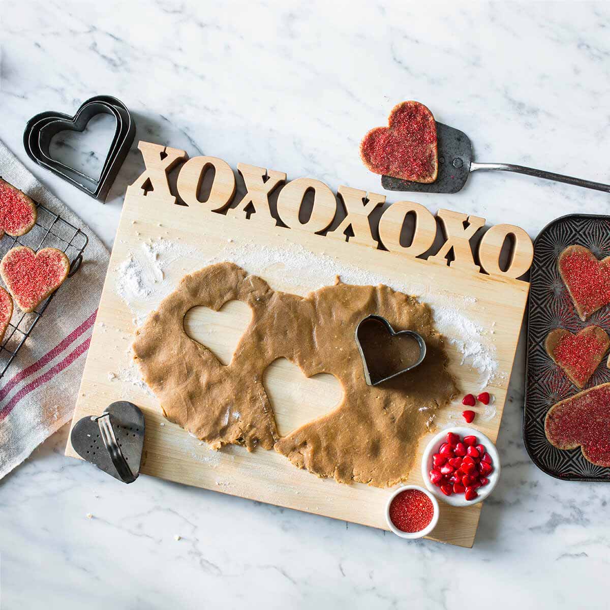 cutting board with XOXOXOXO cut out of the top of maple wood