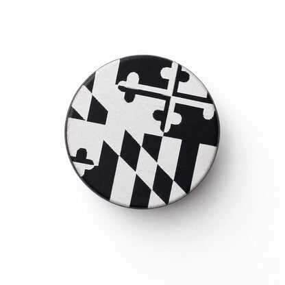 black bottle top, engraved Maryland flag white background
