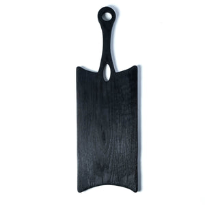 black wooden cutting board, long rectangle shape with handle