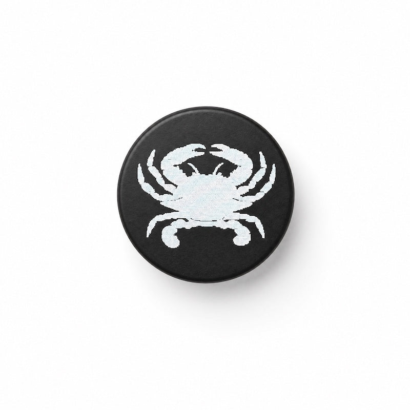 crab image laser engraved on black bottle stopper, white background