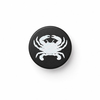 crab image laser engraved on black bottle stopper, white background