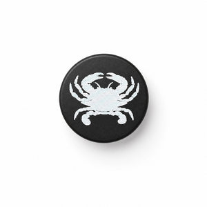 crab image laser engraved on black bottle stopper, white background