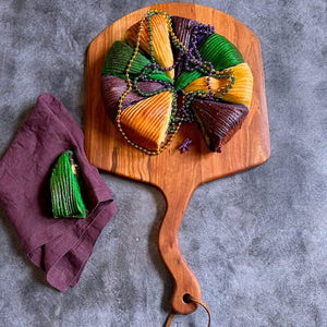 king cake served on wood pizza peel