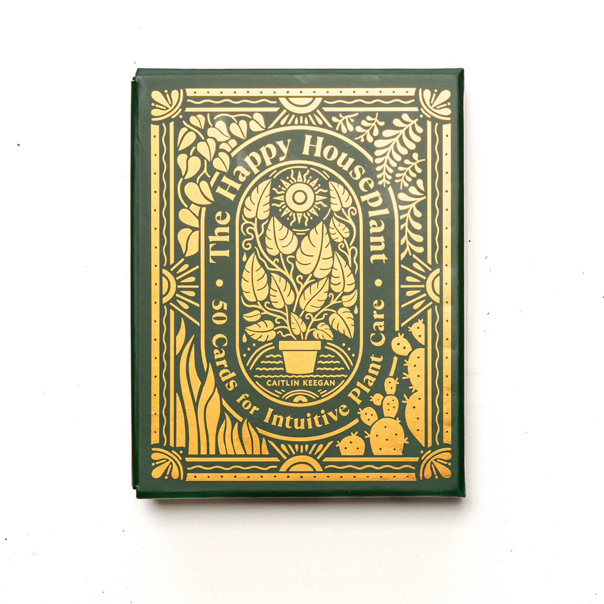 the happy house plant Card deck packaging with green and gold design on a white background