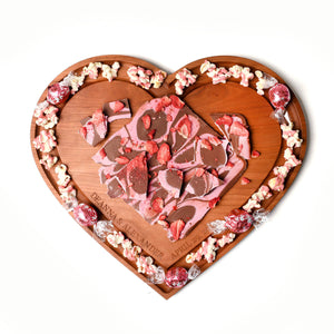 wooden heart shaped board with strawberry bark on top