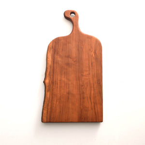 cherry live edge cutting board with hole in handle