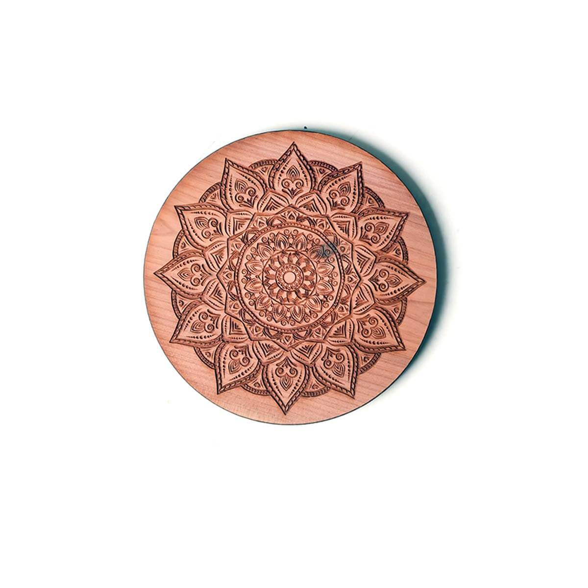 Wooden coaster with a mandala design on a white background