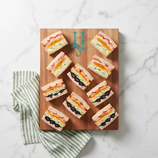 inlay monogram cutting board with tea sandwiches on marble counter