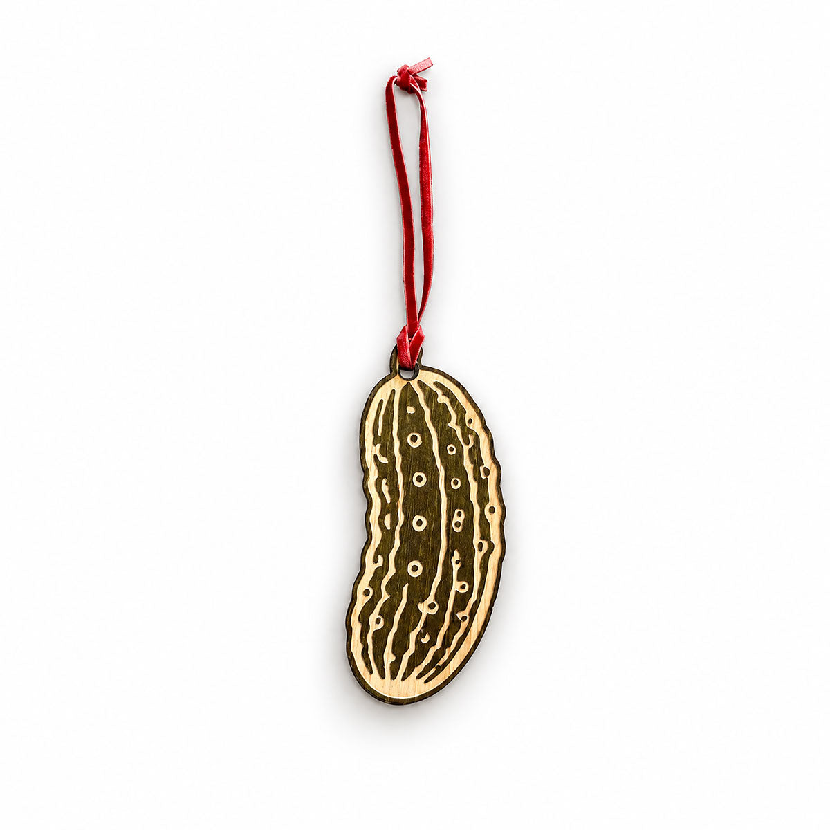 green pickle wooden holiday ornament with red velvet hang tie, white background
