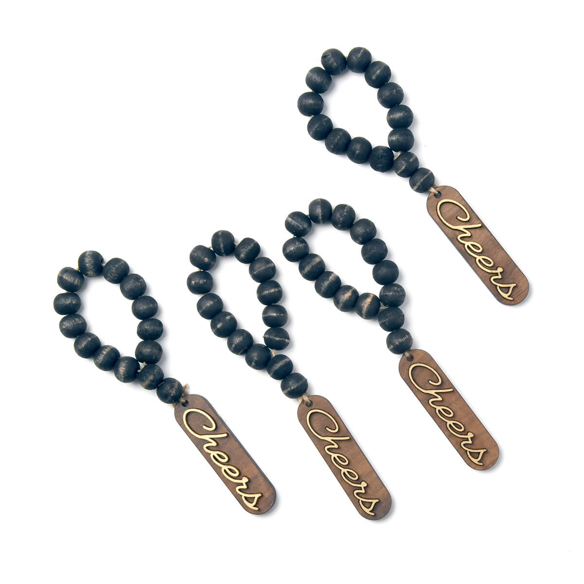 napkin ring made of black wood beads, the word cheers attached to the beads