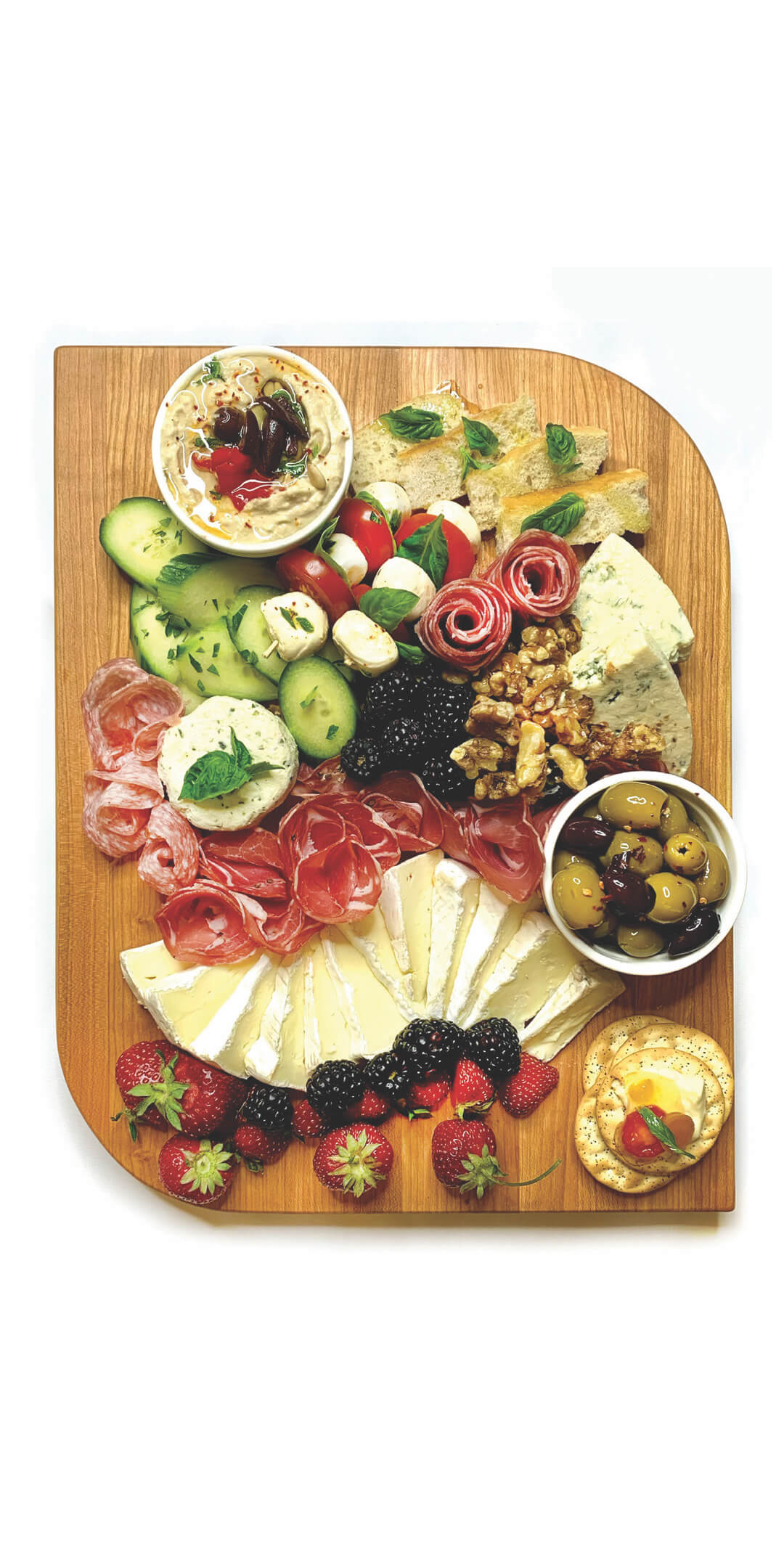 charcuterie displayed on leaf shaped wood board