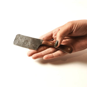 cheese cutting knife shown in a hand