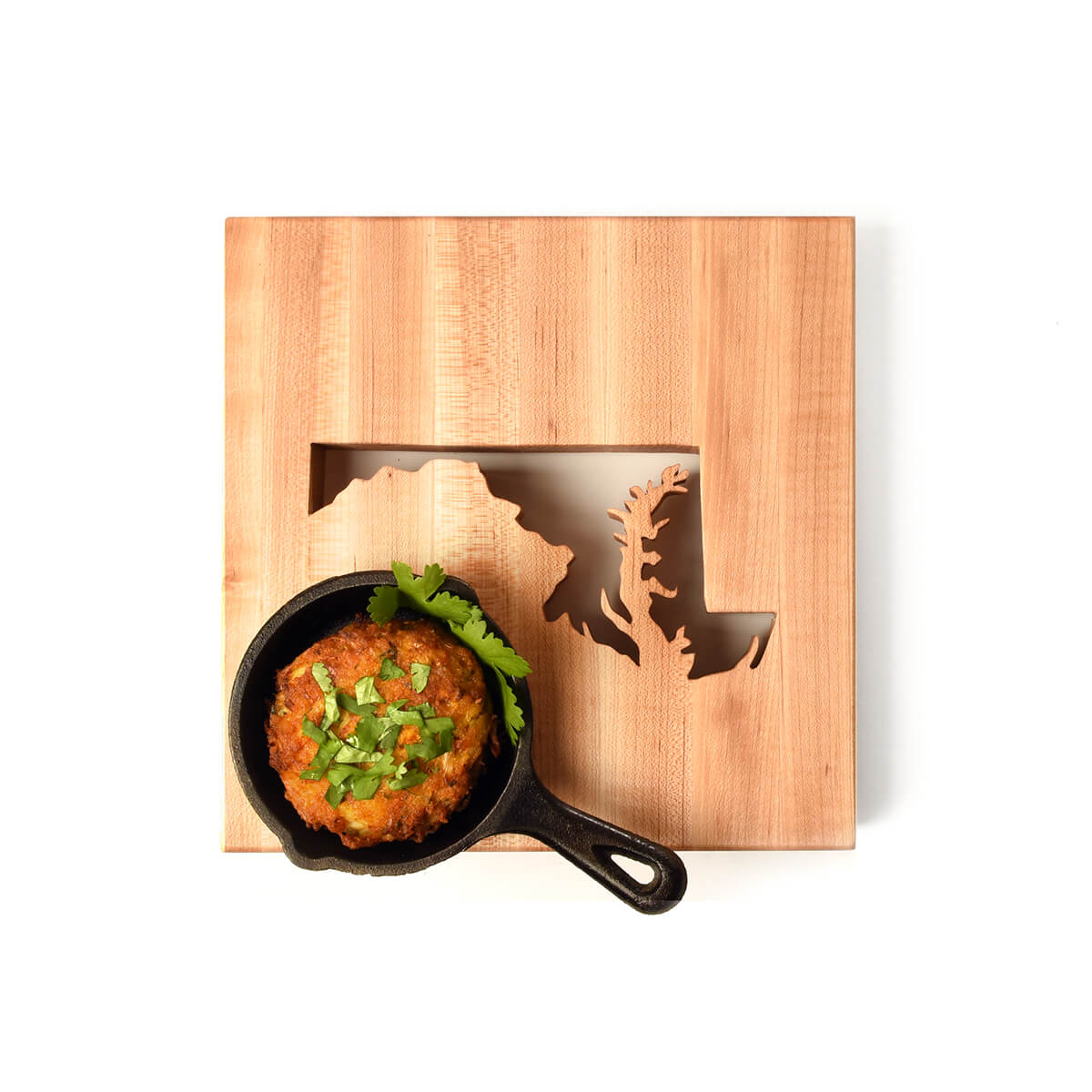 Maryland trivet, state cut out of wood, shown with crab cake in little pan