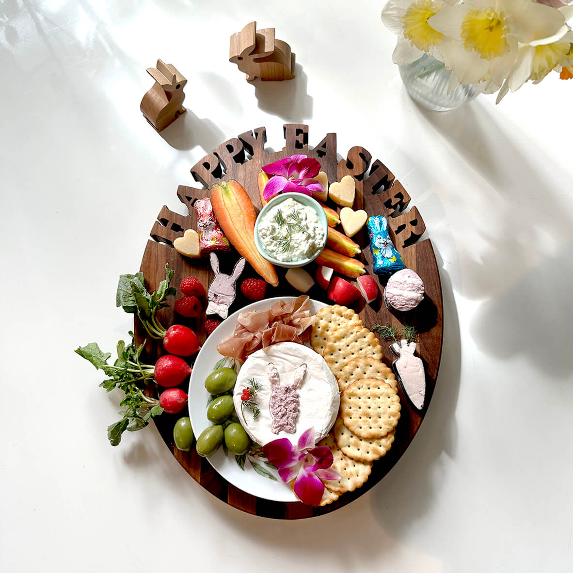Oval cutting board made of walnut wood, words happy Easter cut out on top