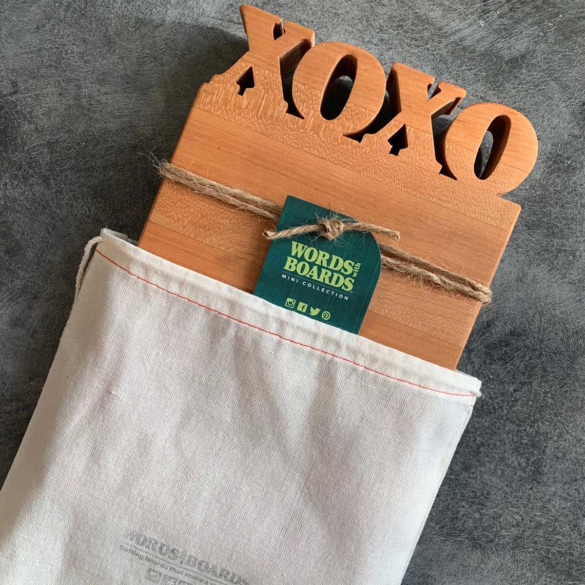 XOXO cutting board coming out of custom Words with Board Bag