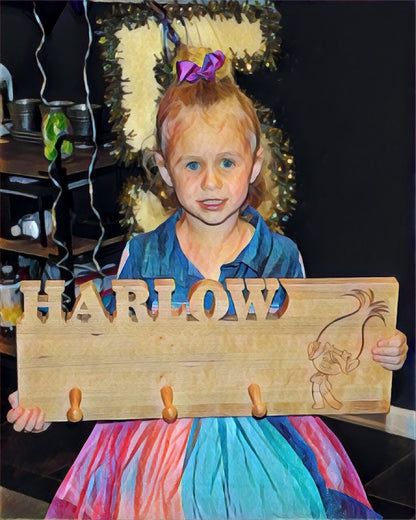 kids coat rack, girl holding her coat rack with her name carved out of the wood