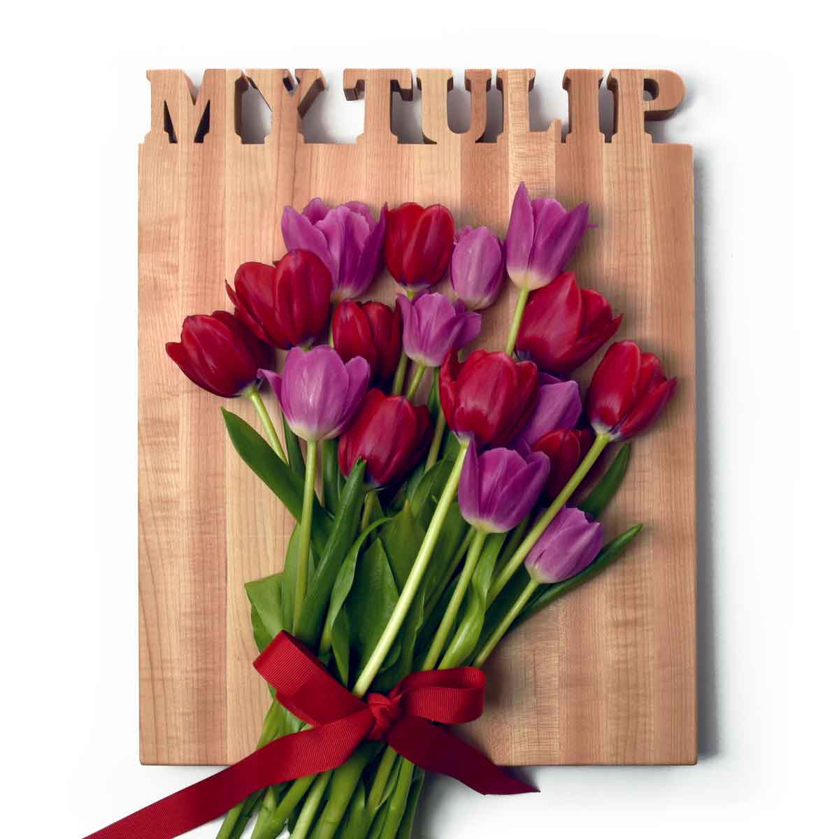 large personalized wooden cutting board, names carved out 