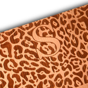 leopard pattern with monogram on a wood cutting board