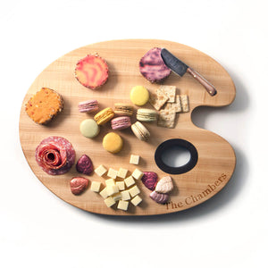 personalized paint palette serving board with a display of cheese and crackers 